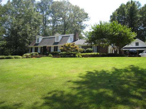 This Vinings home for sale features beautiful, lush landscaping. Listed by Tina Hunsicker.