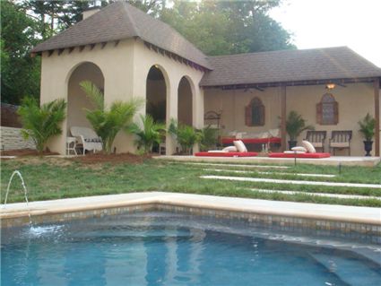An exquisite setting for a swimming pool and adjacent pool house/cabana.