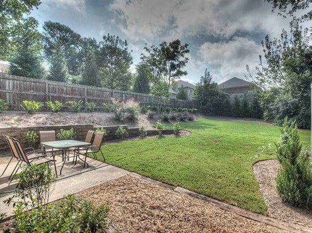 The level backyard is professionally landscaped and features a patio for dining alfresco. Click on the image for more photos and information from my website.